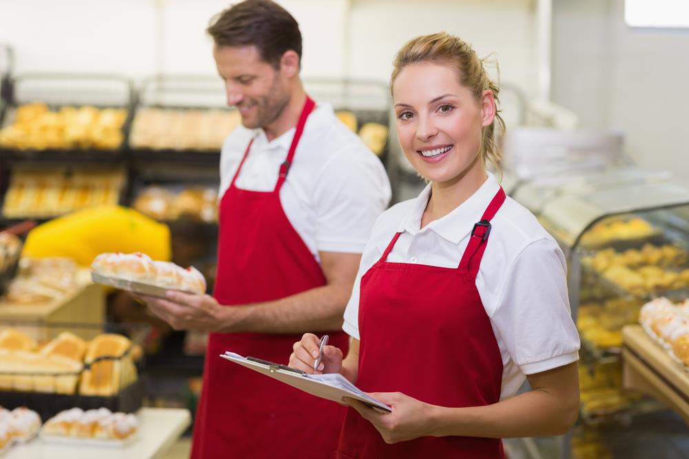 retail store manager checking food inventory with an associate