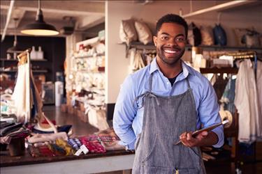 retail store manager smiling in his boutique