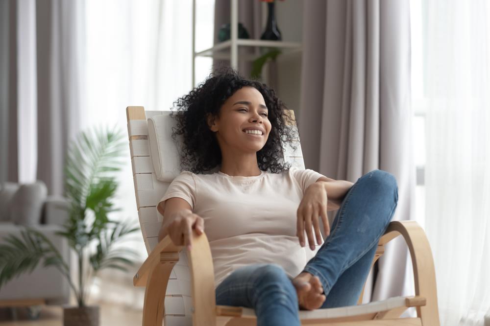 Woman sitting down in a chair. 