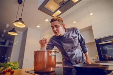 Private chef cooking in home kitchen