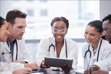 group of smiling medical professionals in a meeting