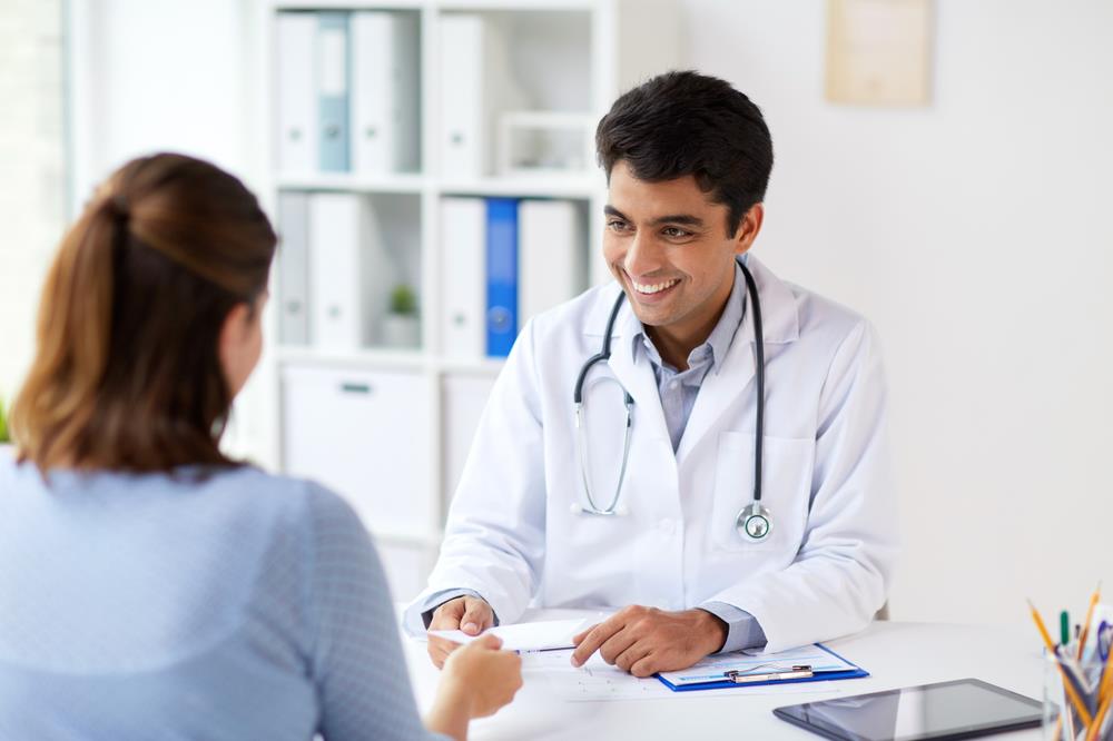 smiling physician meeting with a patient