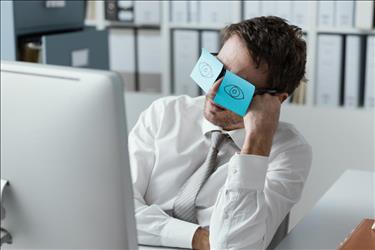 job seeker at his desk with silly post it notes on his eyes