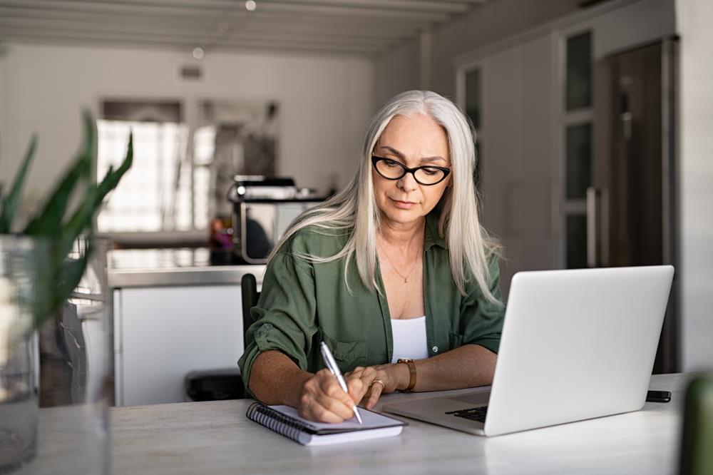 Hiring manager taking notes on a job candidate after an interview