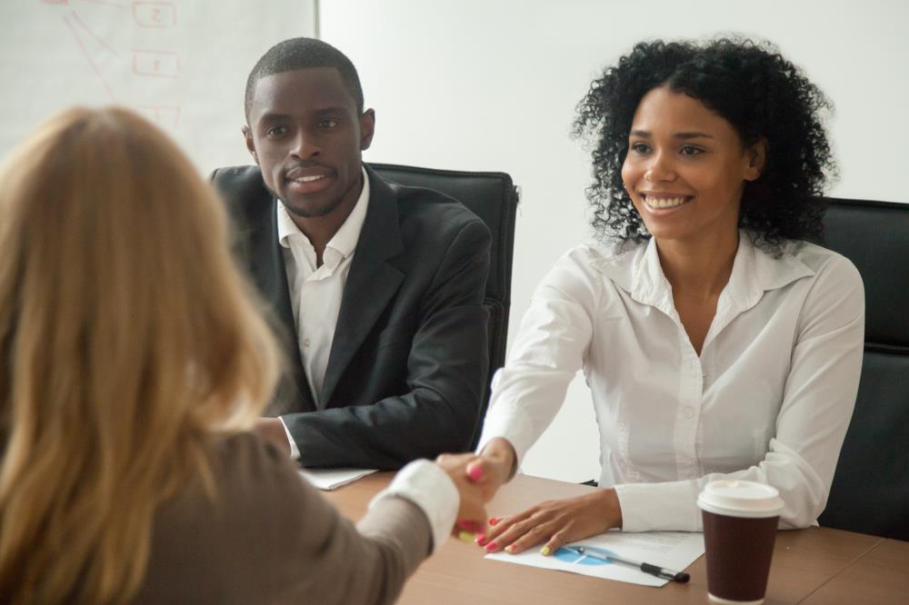 two people interviewing job candidate