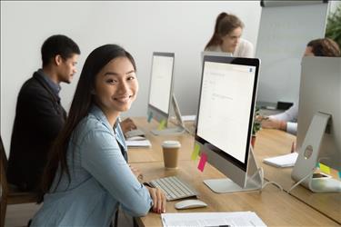 Woman sitting at her desk at her first job