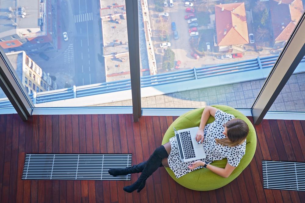 View from above of a job seeker considering how best to arrange quotes on her resume