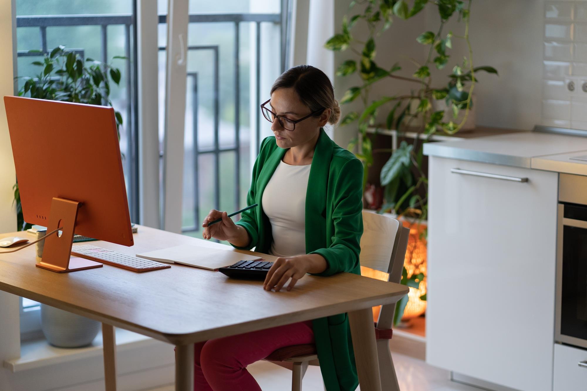 woman in her home office doing calculations