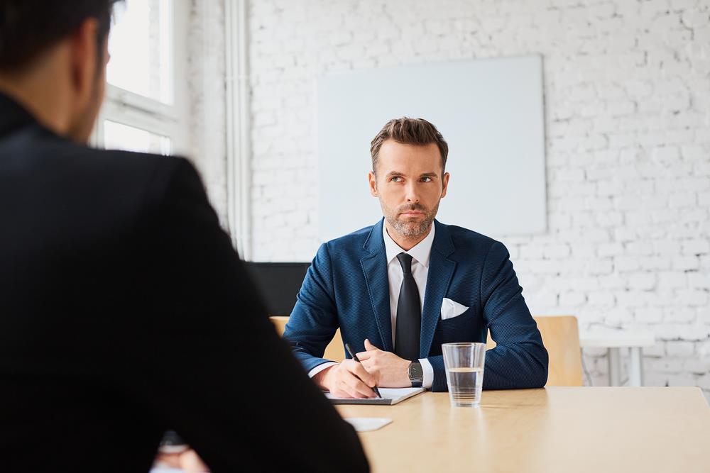 interviewer with a serious face not providing information in return