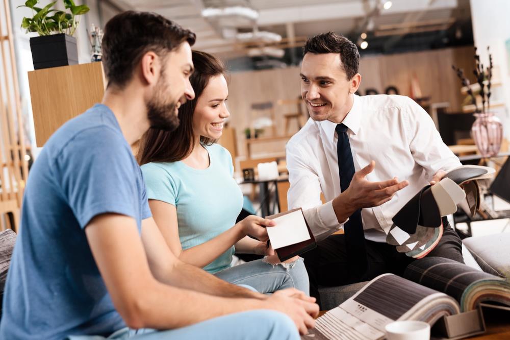 sales representative helping customers purchase furniture