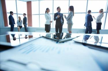 Group of professionals networking in an office conference room