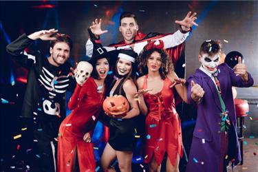 group of employees at a halloween office party