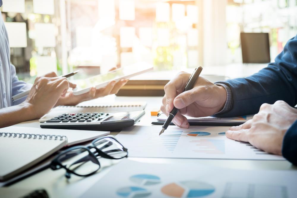 optometry practice manager reviewing financial data with team member