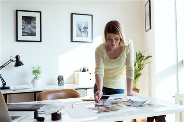 Young woman works on preparing her professional portfolio