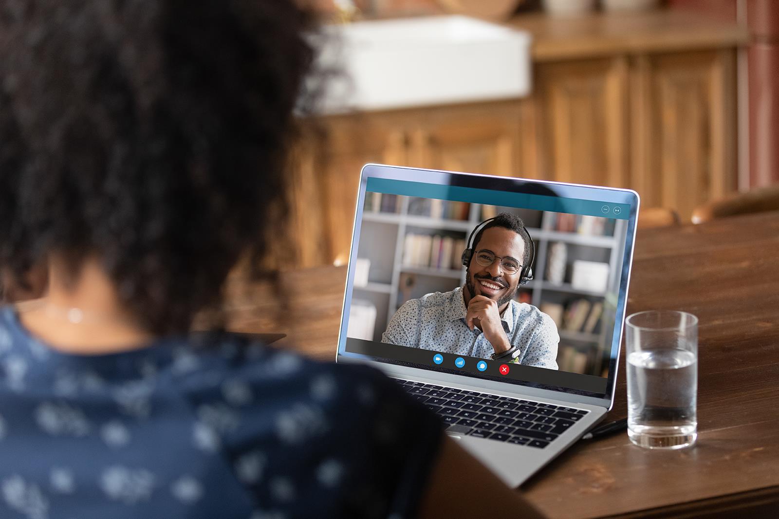 Woman interviewing a man using videoconferencing/Zoom