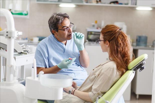 Dentist speaking with patient