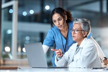 doctor and nurse looking at a laptop together