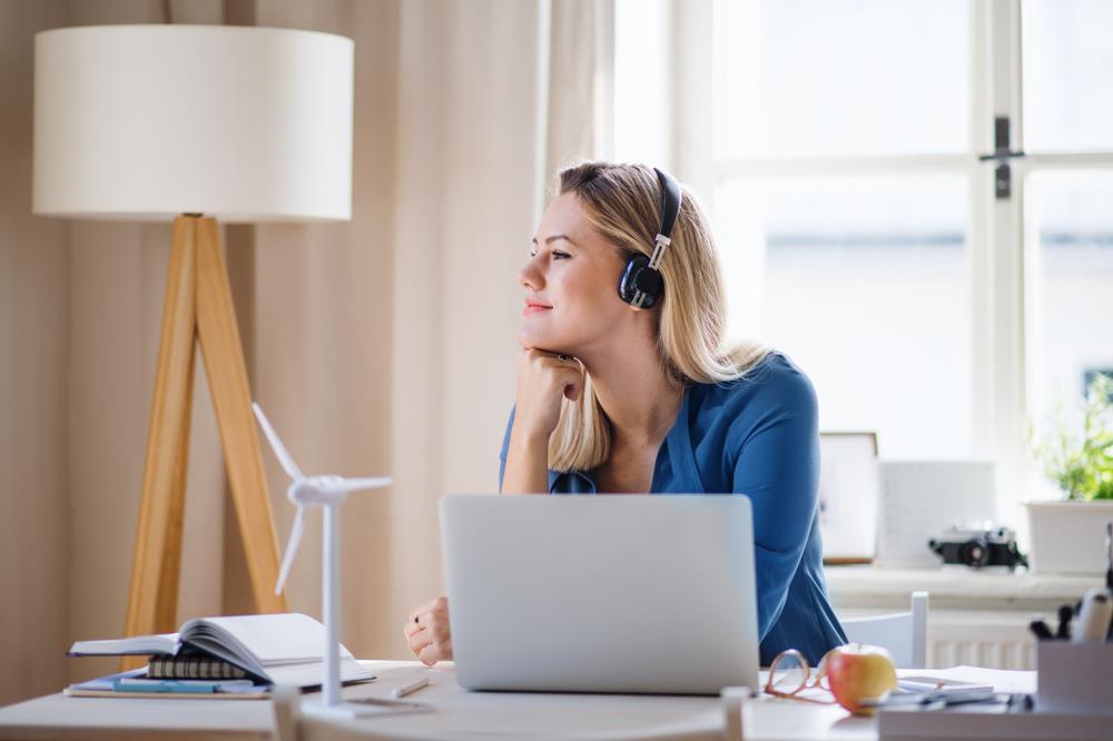 happy remote employee working at her home office