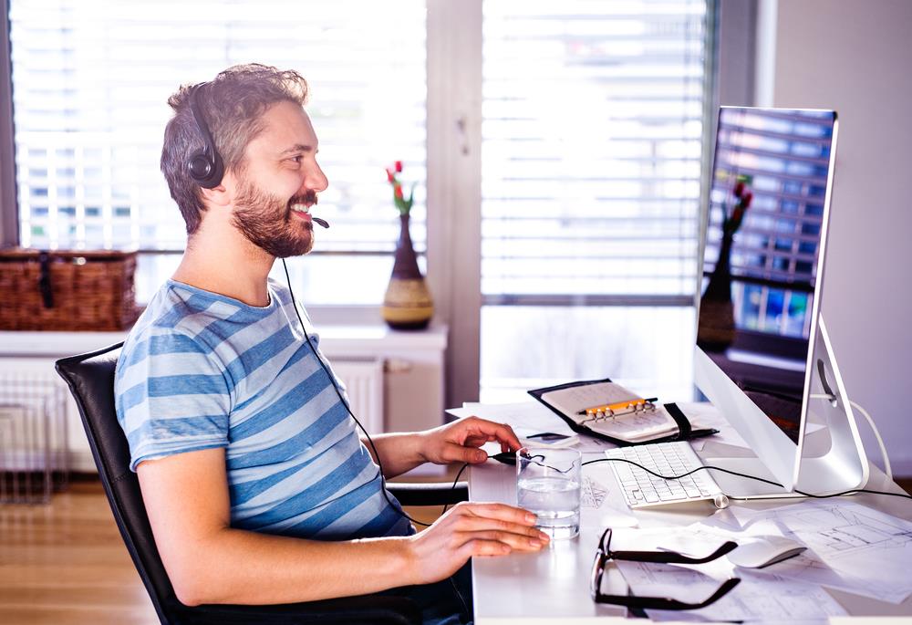 remote employee on the phone with his manager in his home office