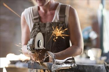 Woman working on a grinder, part of the rising number of female skilled trades professionals