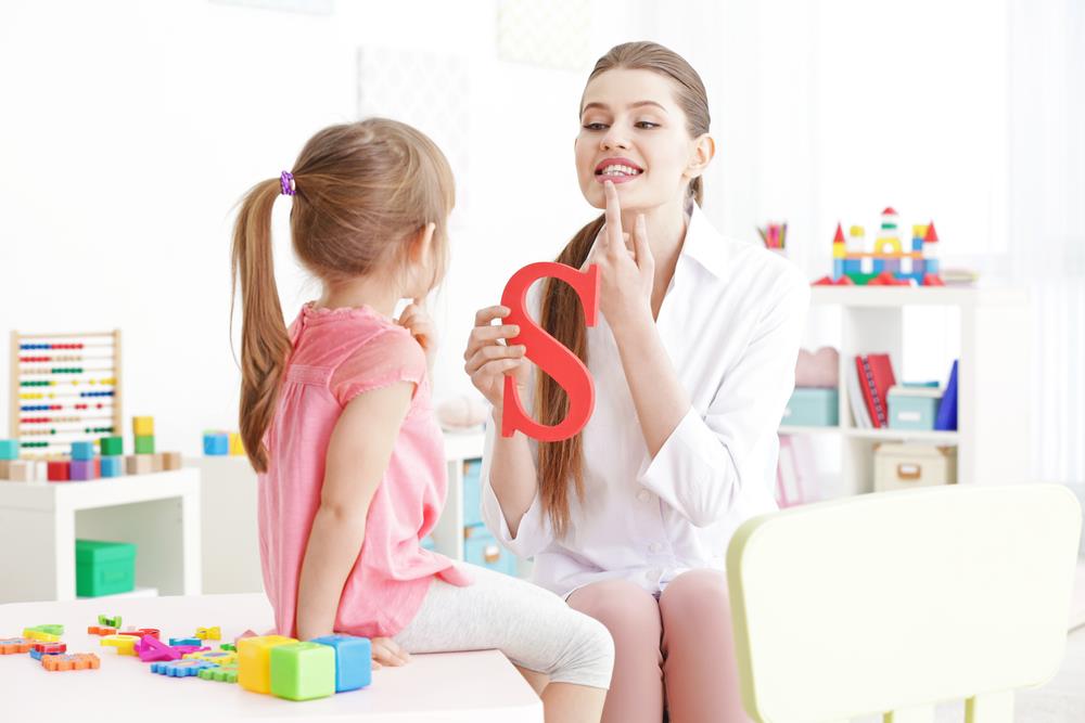 Speech-language pathologist meeting with young girl