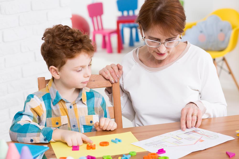 Occupational therapist meeting with young boy