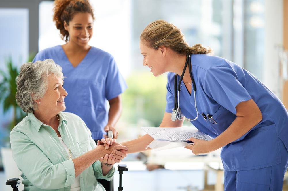 healthcare workers chatting with patient