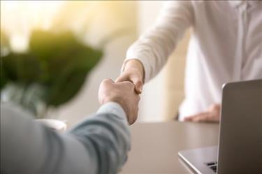 Hiring manager shaking hands with job applicant