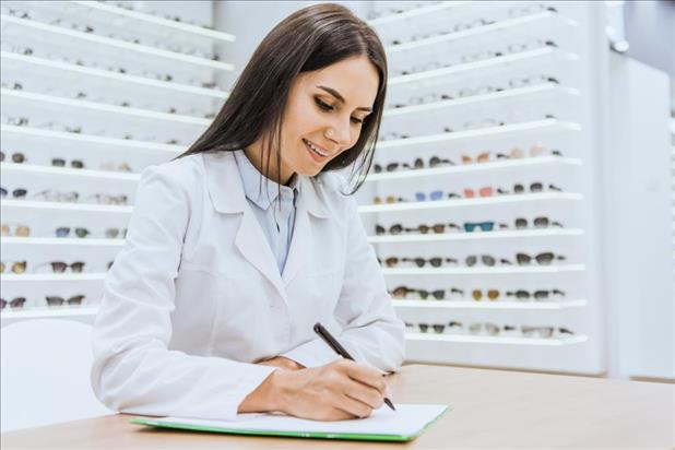 Optician working on paperwork