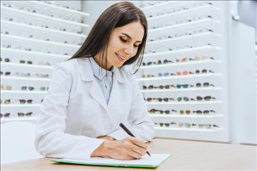 Optician working on paperwork