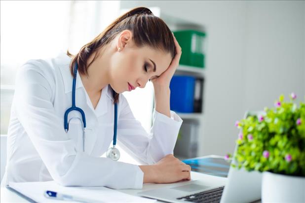 tired nurse taking a break at her desk