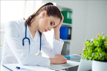 tired nurse taking a break at her desk