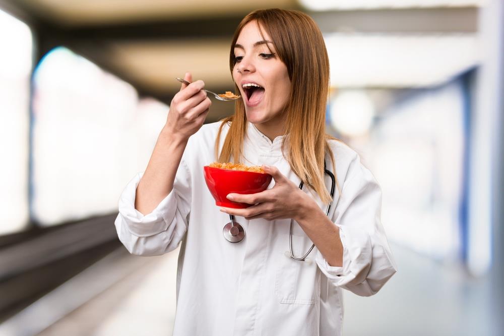 nurse having a bowl of cereal during her work break