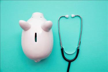 piggy bank next to a stethoscope