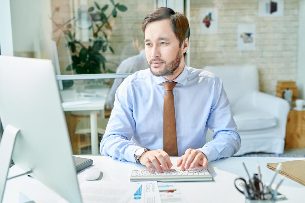 Man Writing on Computer