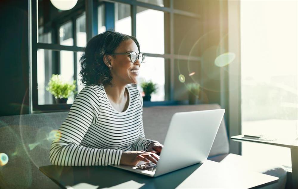 Woman Smiling and Writing