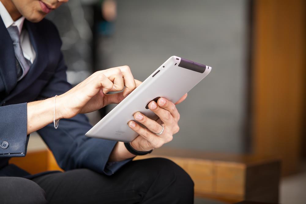 job seeker on his tablet networking on social media