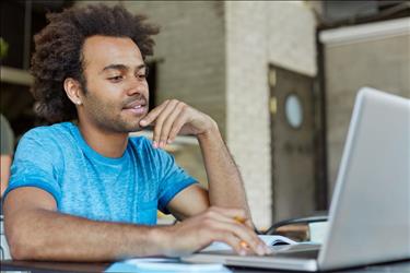 male marketing professional taking an online course on his laptop