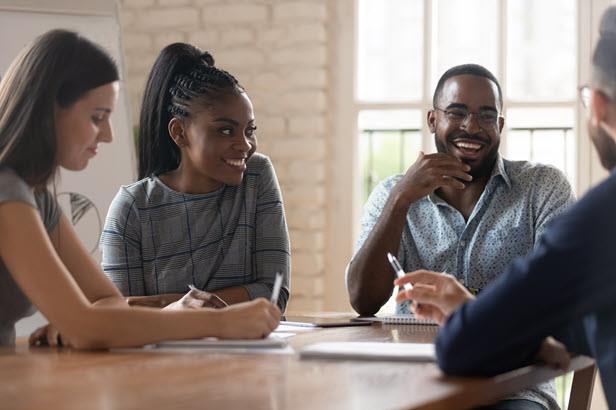 happy employees chatting at a table