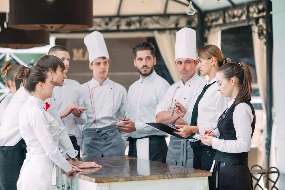 restaurant team and hospitality employees having a meeting