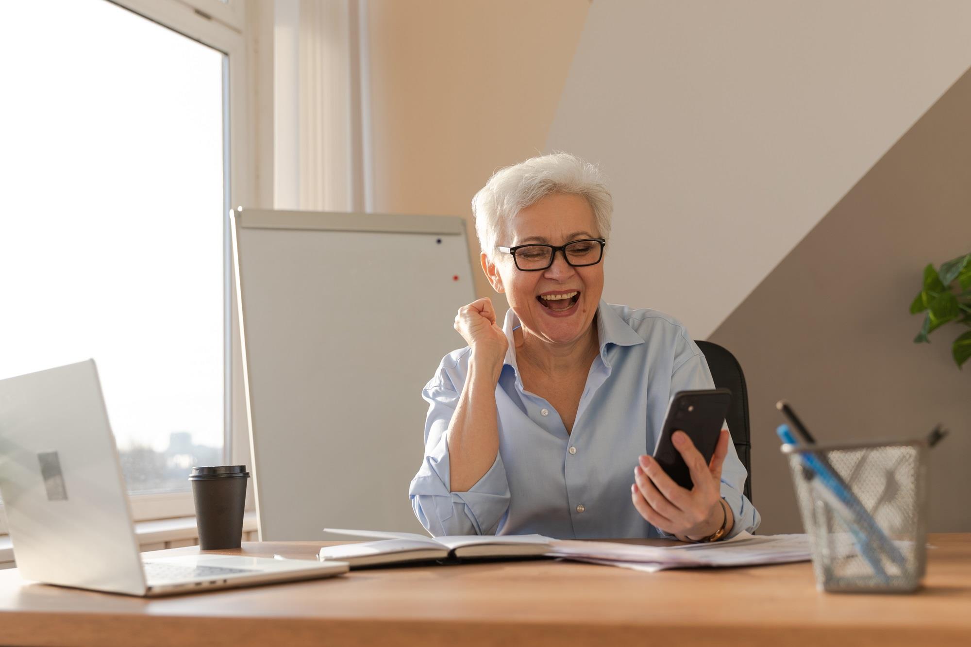 happy HR pro looking at her phone