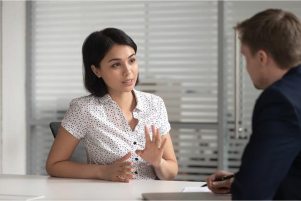 woman speaking to employer at desk