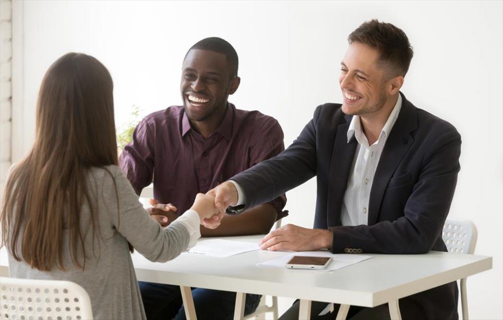 Woman shaking hands with man